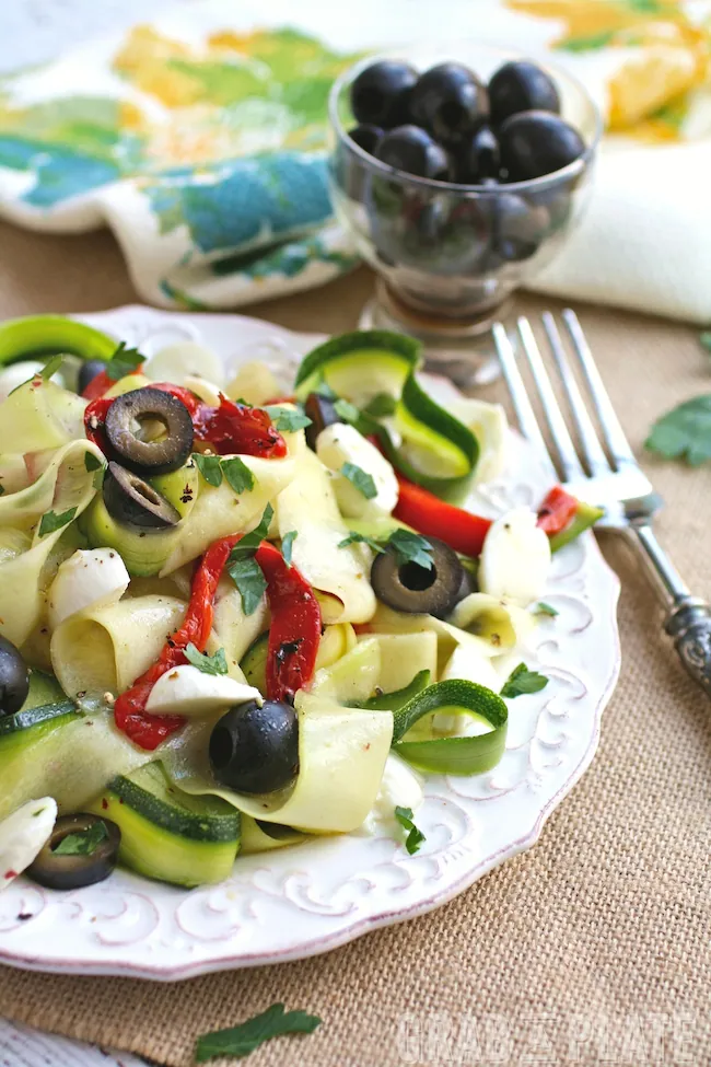 Dig into a Mediterranean-inspired, seasonal meal: Chilled Zucchini Ribbon "Pasta" with Black Olives, Roasted Red Peppers and Mozzarella
