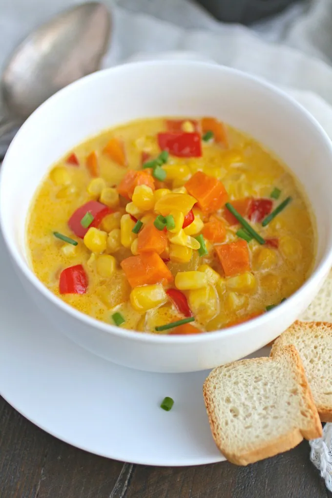 This recipe for Corn and Sweet Potato Chowder with Saffron Cream is rich, colorful, and hearty!