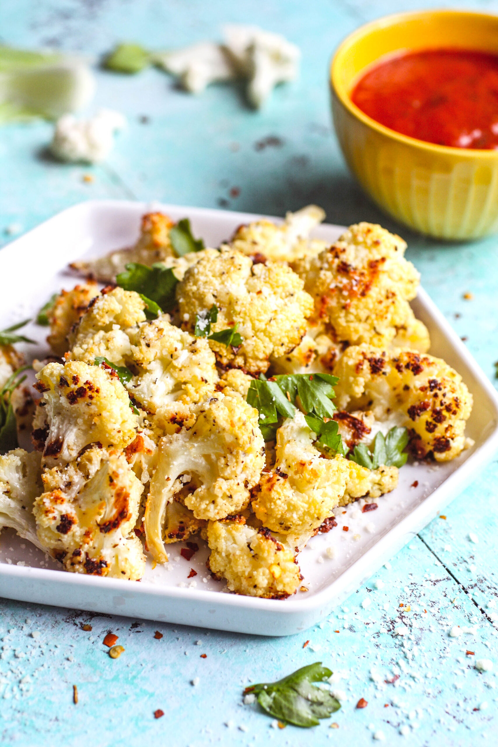 Parmesan & Herb Roasted Cauliflower Bites are a fun and tasty snack. A dish of Parmesan & Herb Roasted Cauliflower Bites is all you need to satisfy hunger for a healthy option.