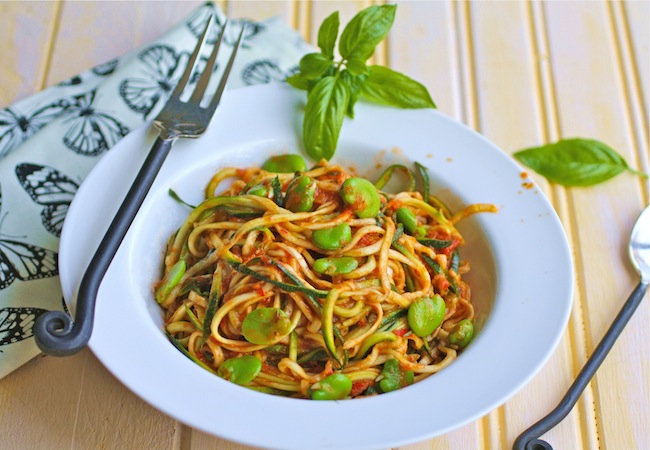 Bolw of zucchini pasta with fava beans and harissa sauce