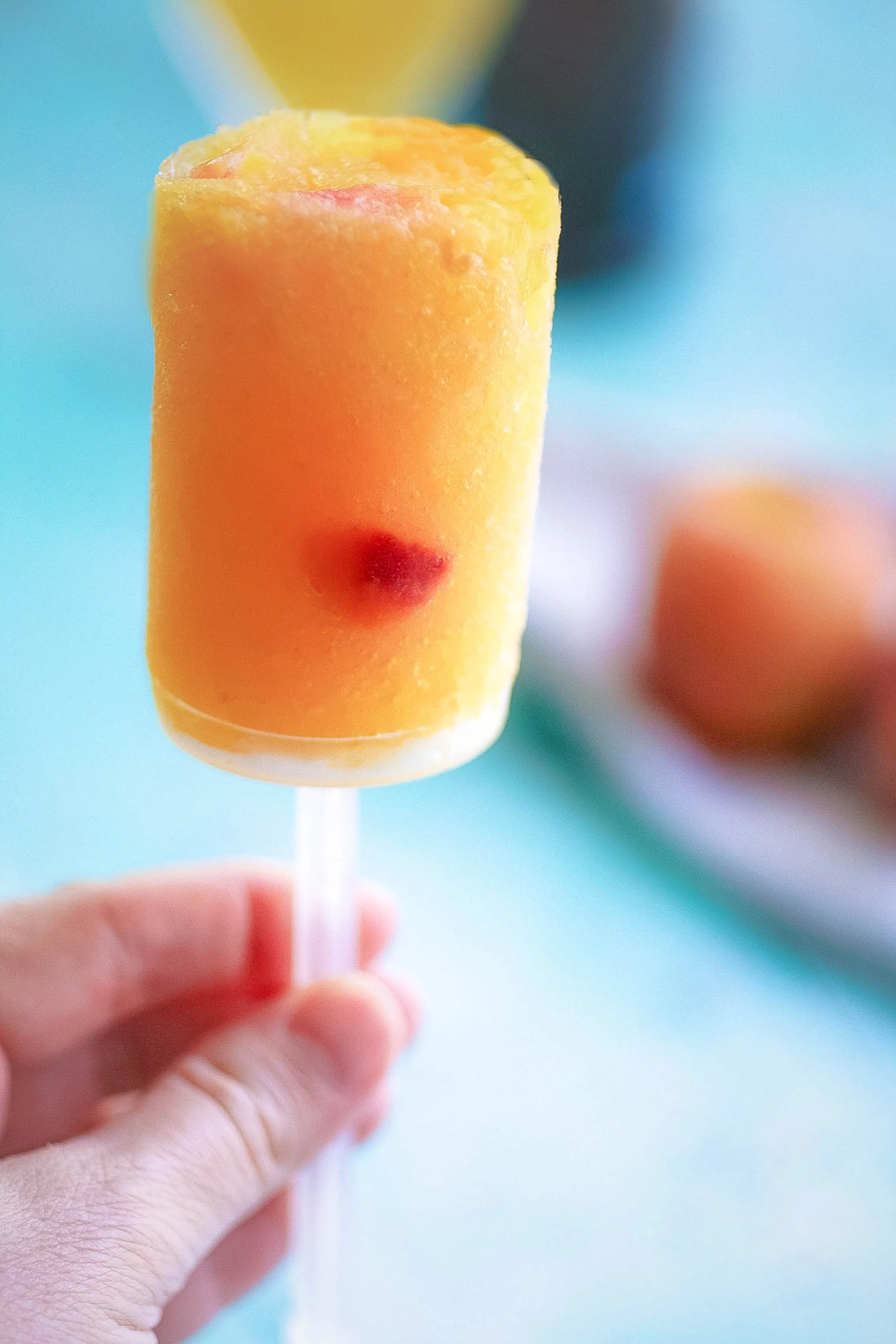 Frozen Peach Bellini Push Pops are a tasty and fun way to chill in the summer. Frozen Peach Bellini Push Pops are fun for adults to enjoy this summer.