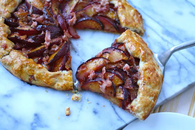 A warm slice of Sweet and Savory Plum and Prosciutto Galette