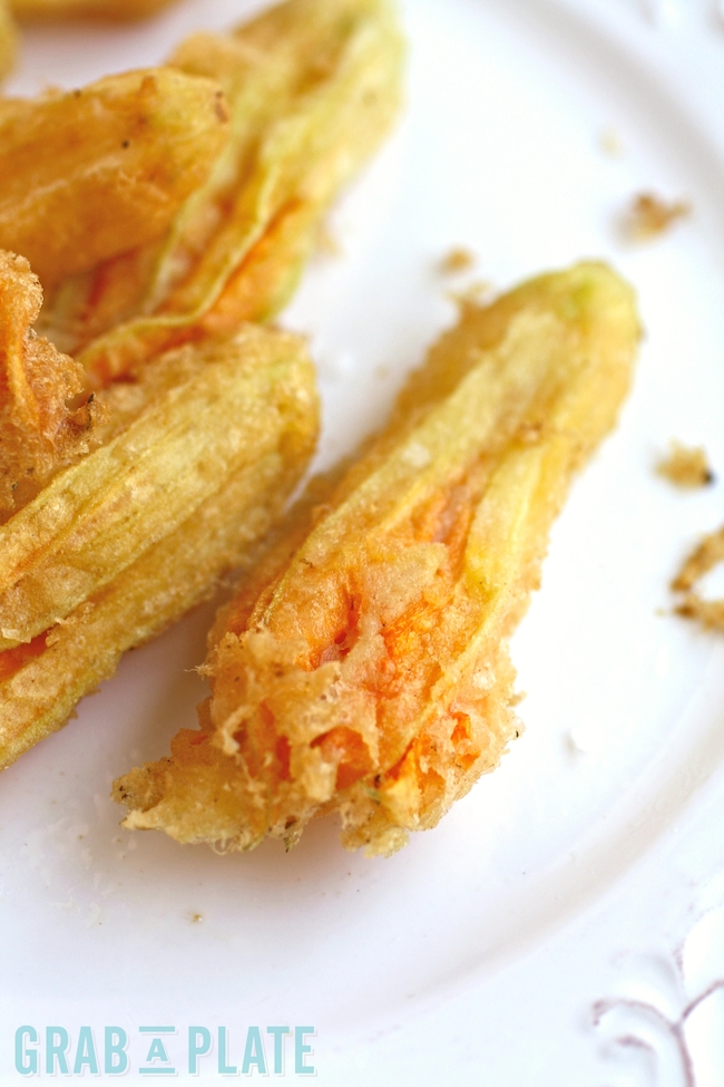 A single Fried Zucchini Blossom ready to enjoy as an appetizer