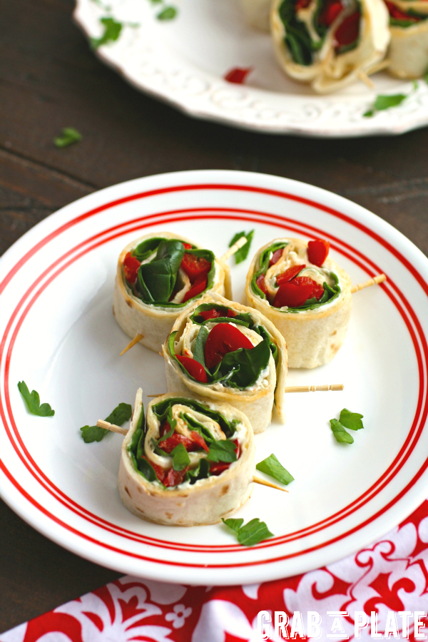 Delight in a plate of Easy Swiss, Spinach, and Red Pepper Pinwheels!