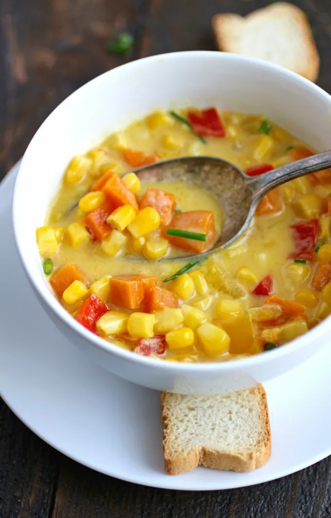 Grab a spoon and dig into Corn and Sweet Potato Chowder with Saffron Cream!