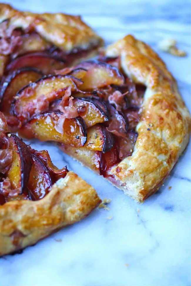 A piece of Sweet and Savory Plum and Prosciutto Galette